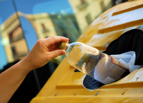 Waste removal trucks driving through Westminster streets