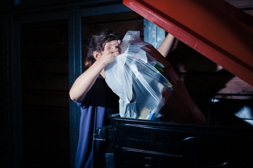 Sorting facility with workers separating glass, paper and plastics at a transfer station